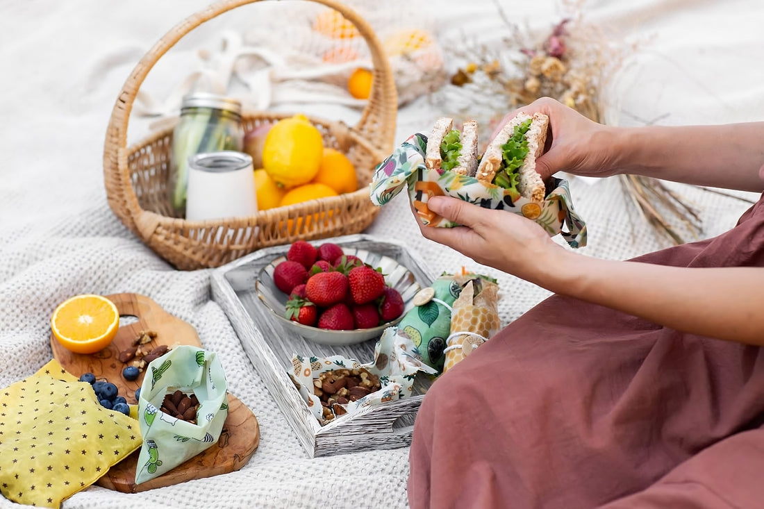 A sustainable kitchen product, beeswax wraps, featured in an eco-friendly outdoor meal with reusable products as gift ideas